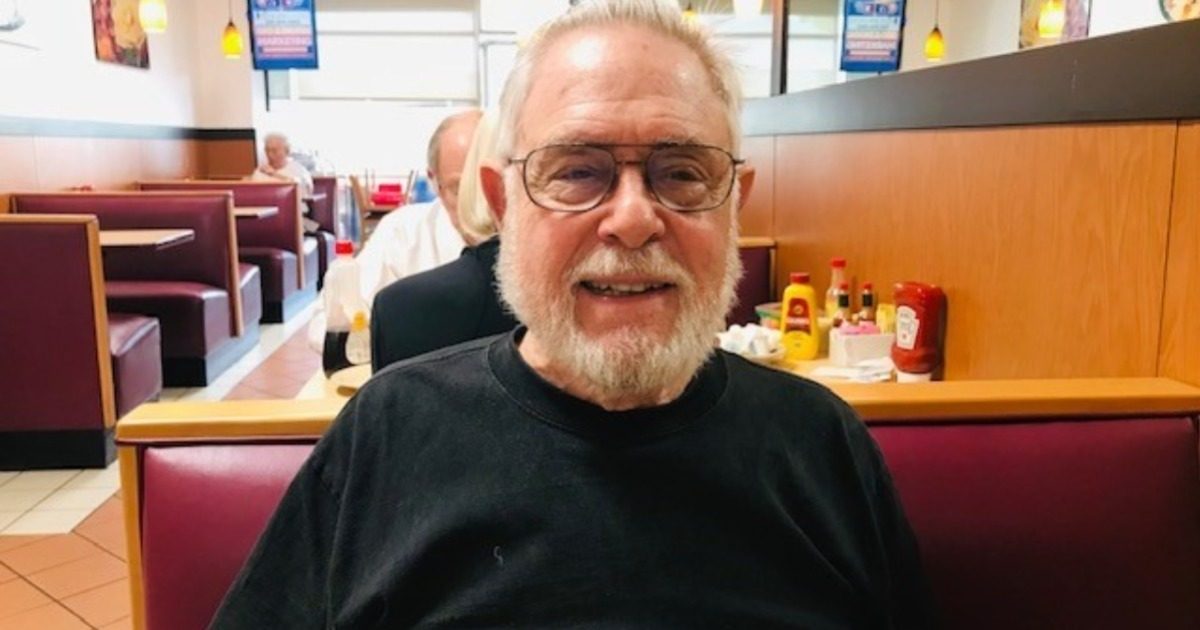 Bill Middelthon sitting at a restaurant table in a black shirt.